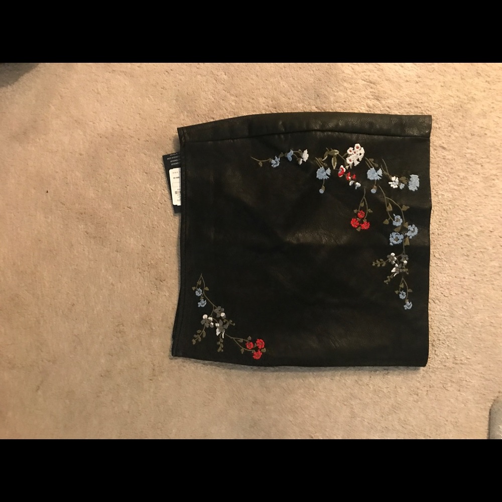 Embroidered black leather skirt